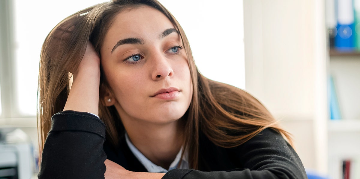 Woman leaning her head against her hand