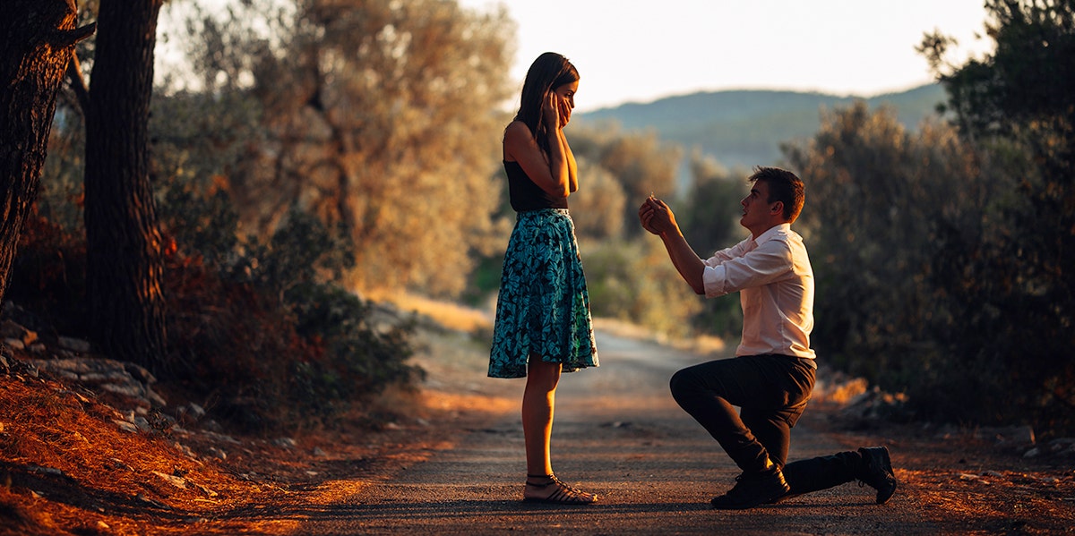 woman being proposed to in woods