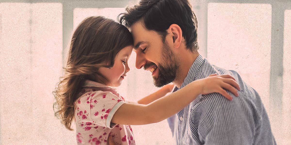 a little girl embracing her dad