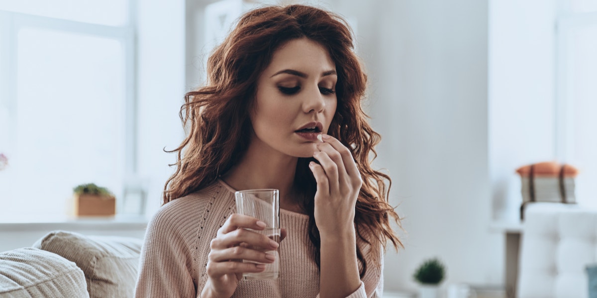 woman taking pill