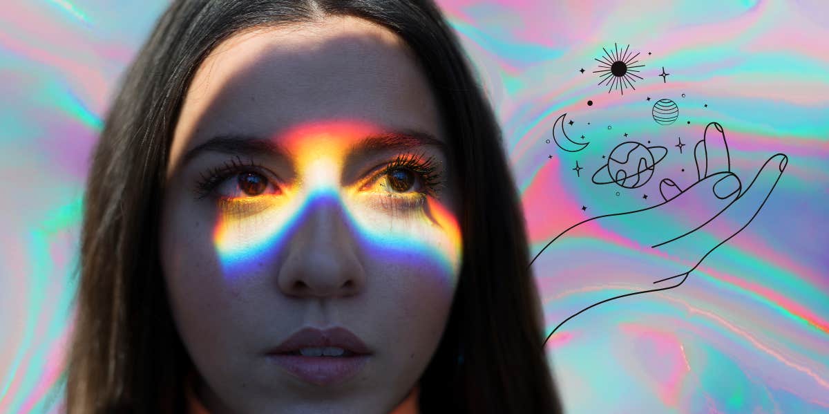 woman with rainbow on eyes, hand holding planets