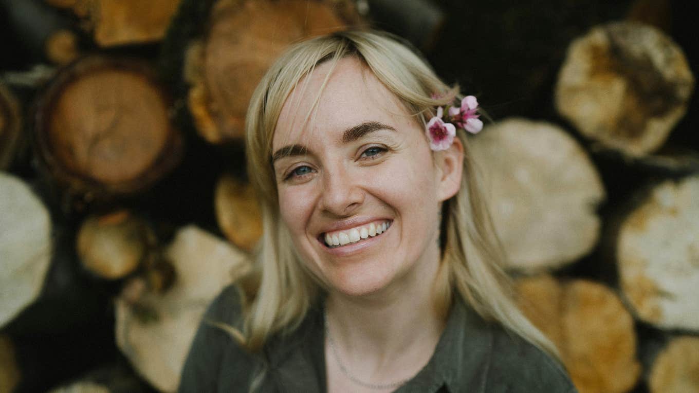 woman smiling with flower in hair