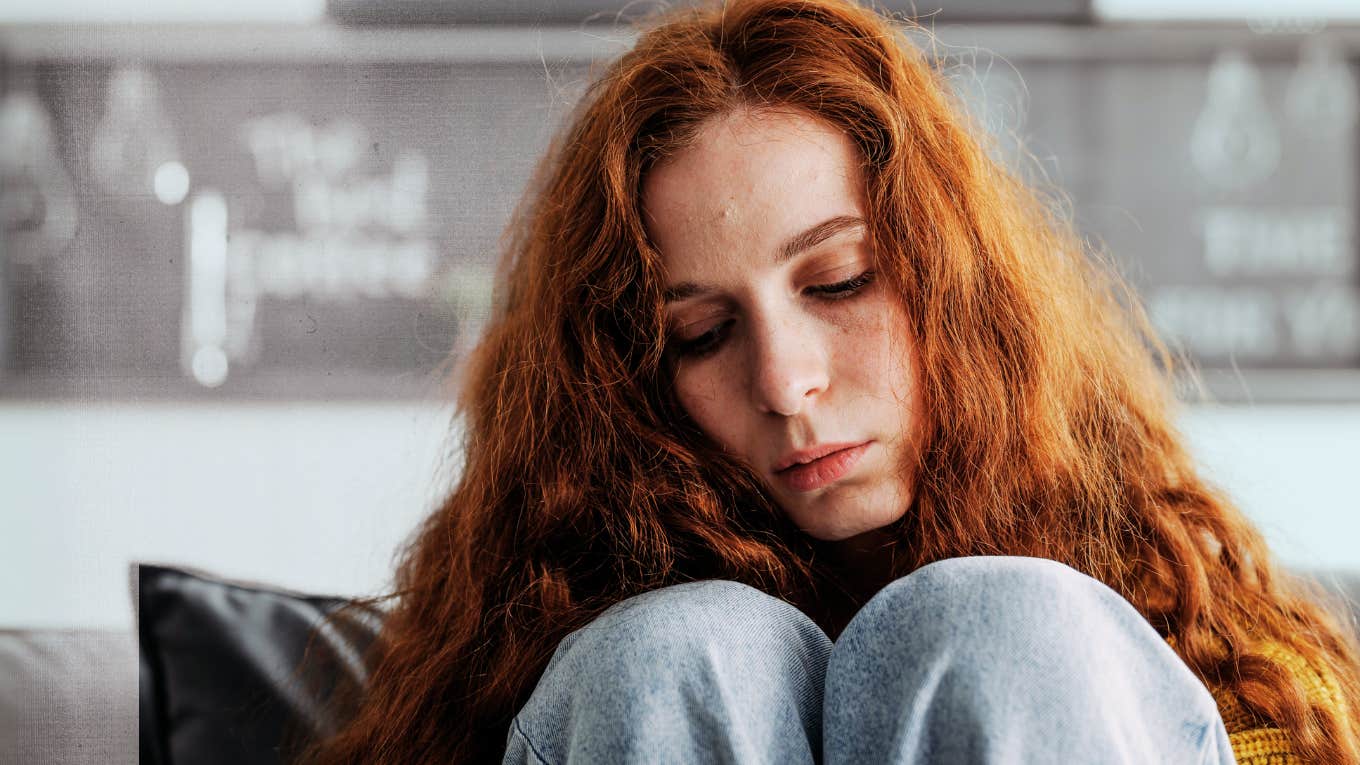 Woman feeling emotional with knees to chest