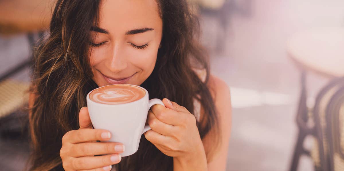 A Psychologist Explains Why You Love Your Cup Of Coffee & Have A Caffeine Addiction woman drinking coffee