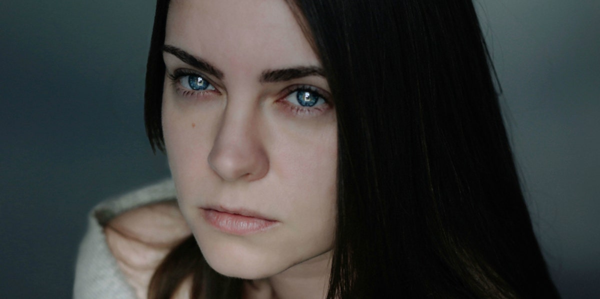 5 Personality Traits Of Psychopaths Who Are Ordinary, Everyday People woman with black long hair staring into camera