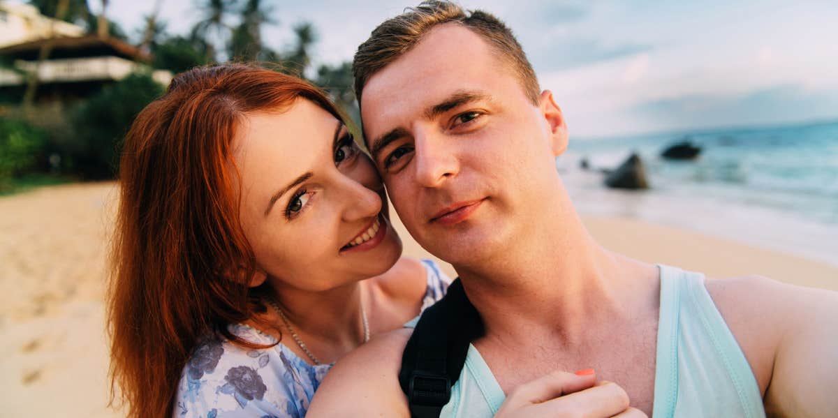 couple taking selfie on the beach