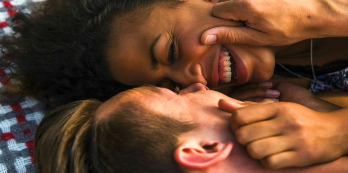 couple smiling in bed with each other