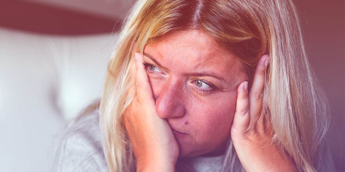 unhappy woman with hands on face