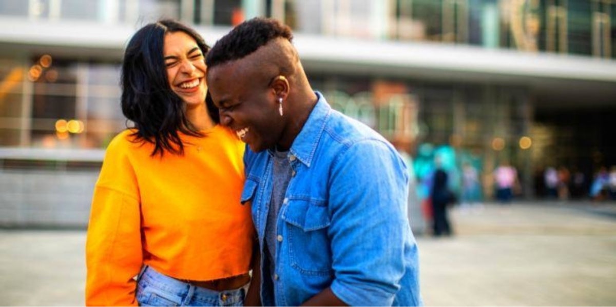 couple in orange and blue laughing and smiling