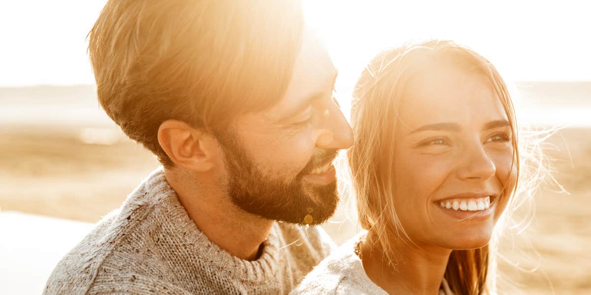 happy man and woman on the beach