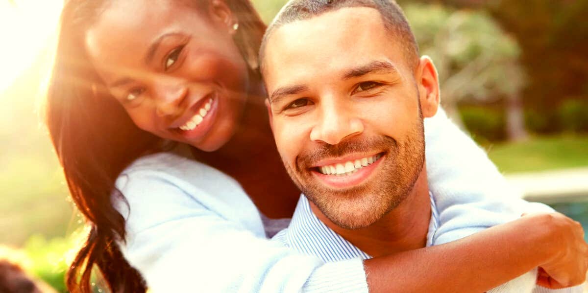 happy man and woman smiling at the camera