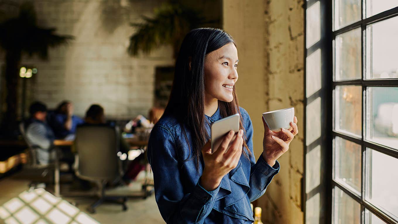 9 Tiny Energy Hacks That Will Instantly Make You More Productive woman looking out window at work