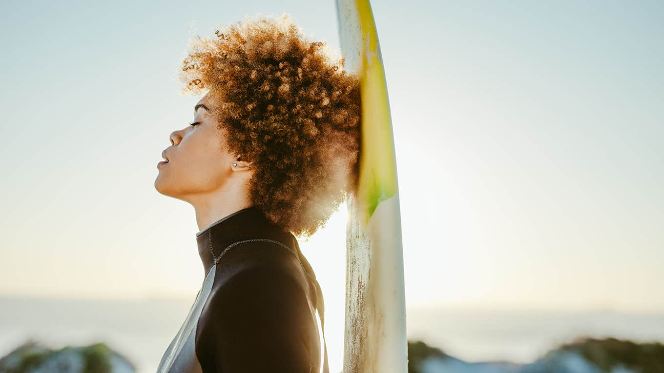 surfer woman breathing with closed eyes