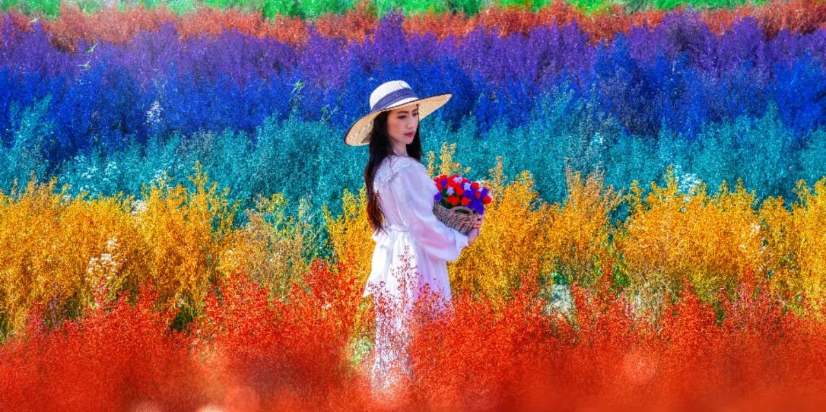 woman standing in front of a rainbow