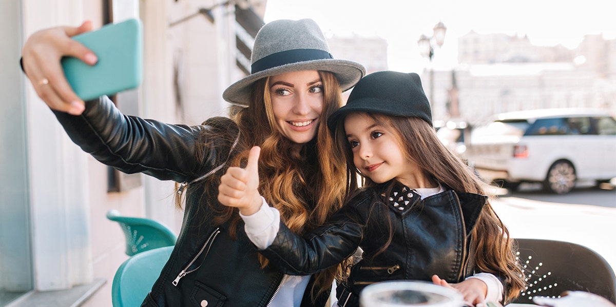 mom taking a selfie with daughter