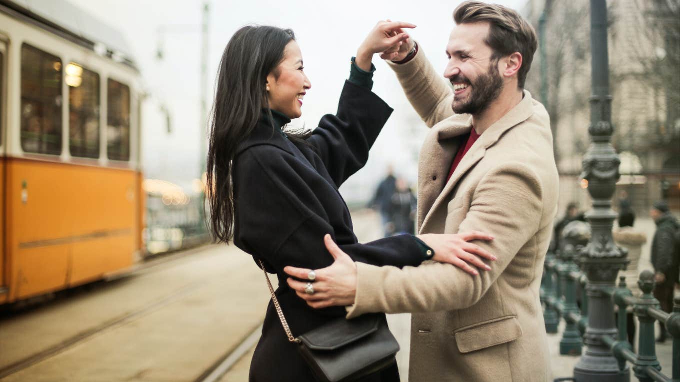 happy couple dancing outside