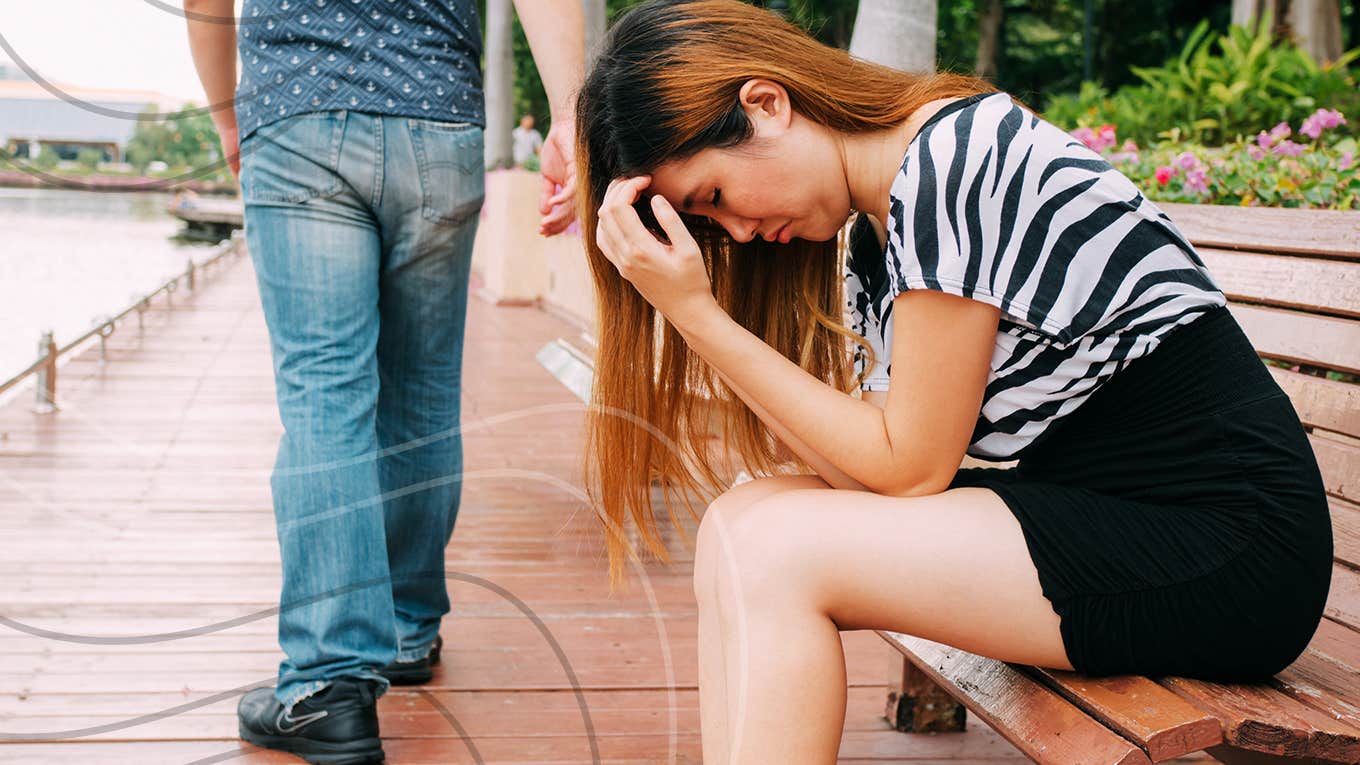 woman sitting on bench sad