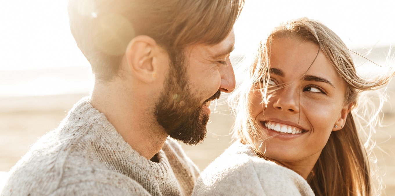 A man and a woman are looking at each other lovingly.