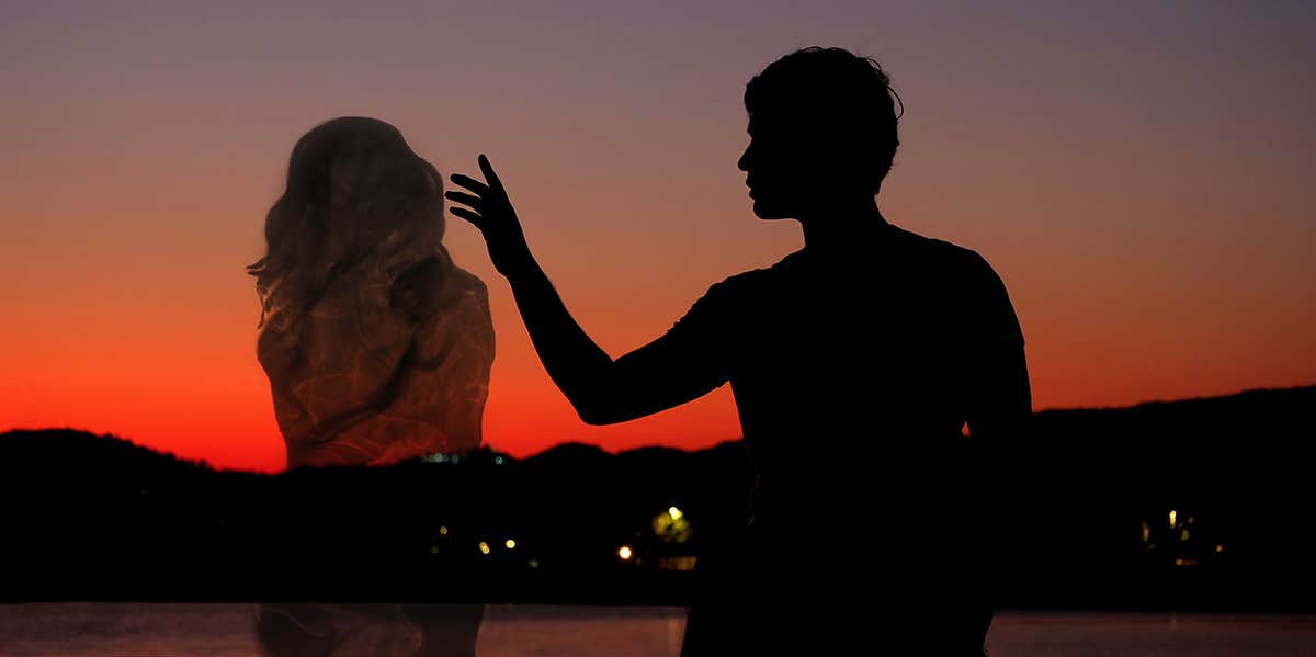 silhouette of man and soulmate at sunset