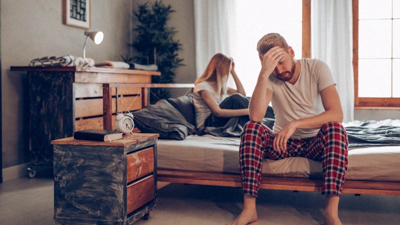 man and woman arguing in bed