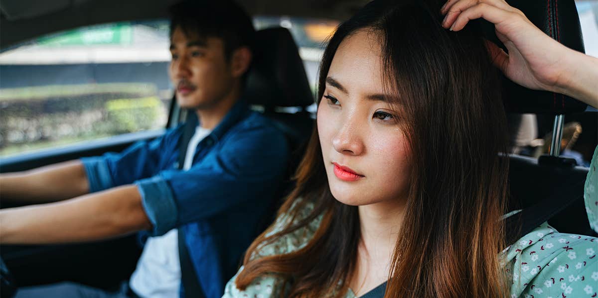 unhappy woman in car with boyfriend