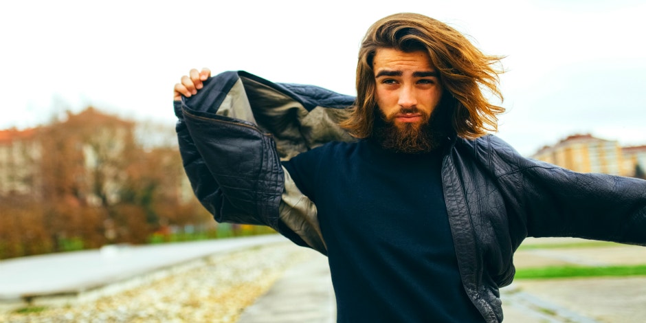 guy holding jacket in the wind