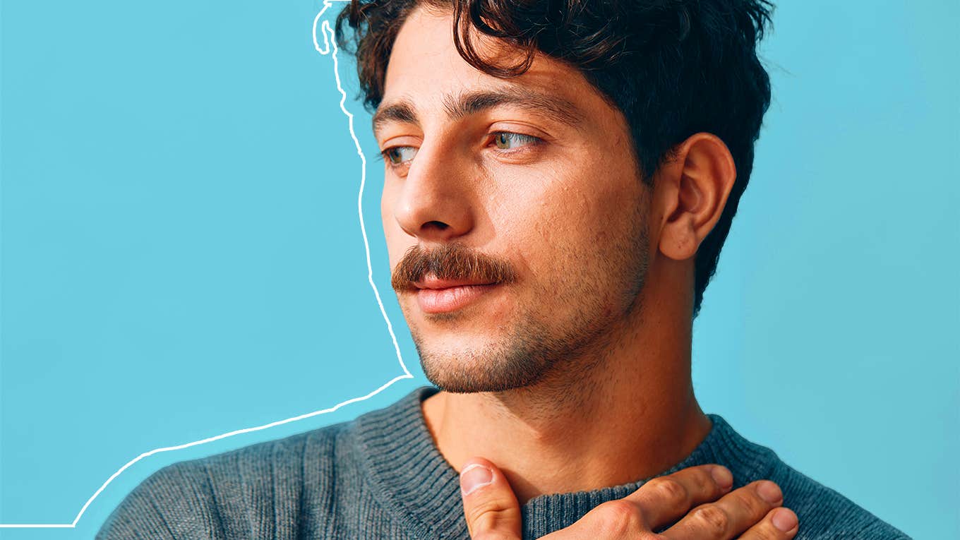 attractive young man against blue background