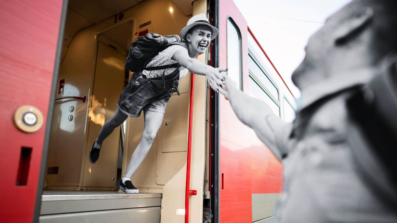 two people grasping for each other on train