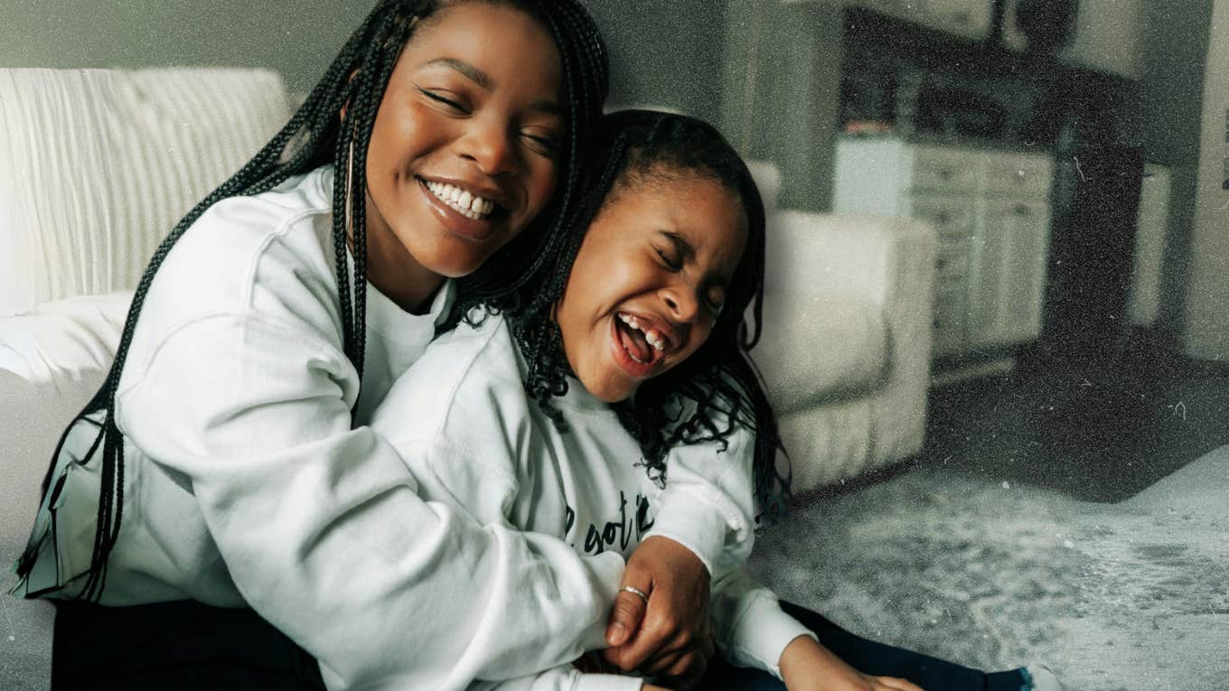 Mom hugging her daughter tightly laughing 