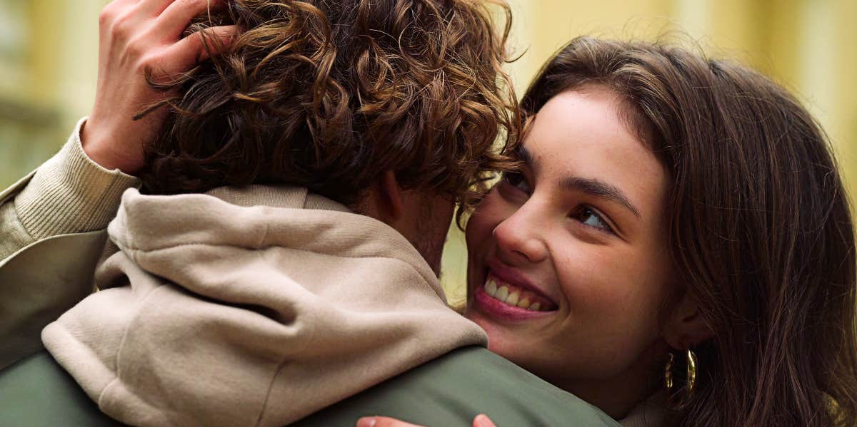 Happy young woman hugs boyfriend