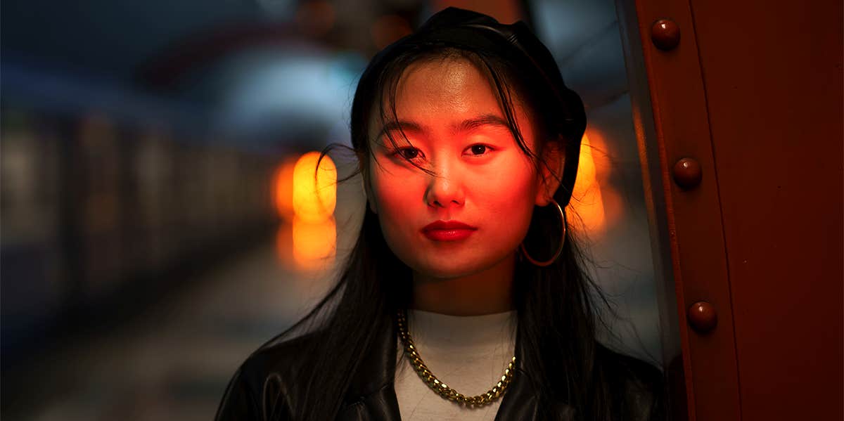 woman standing in dark subway