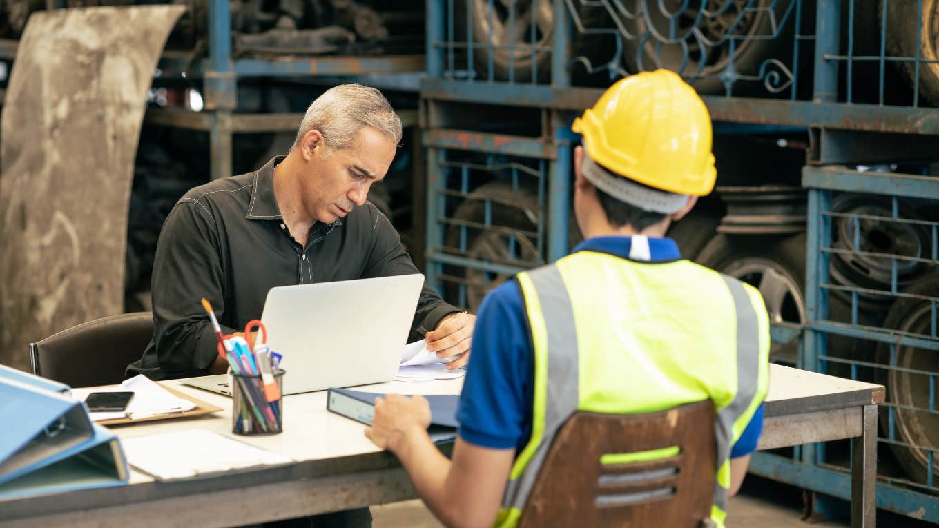 manager interviewing factory worker