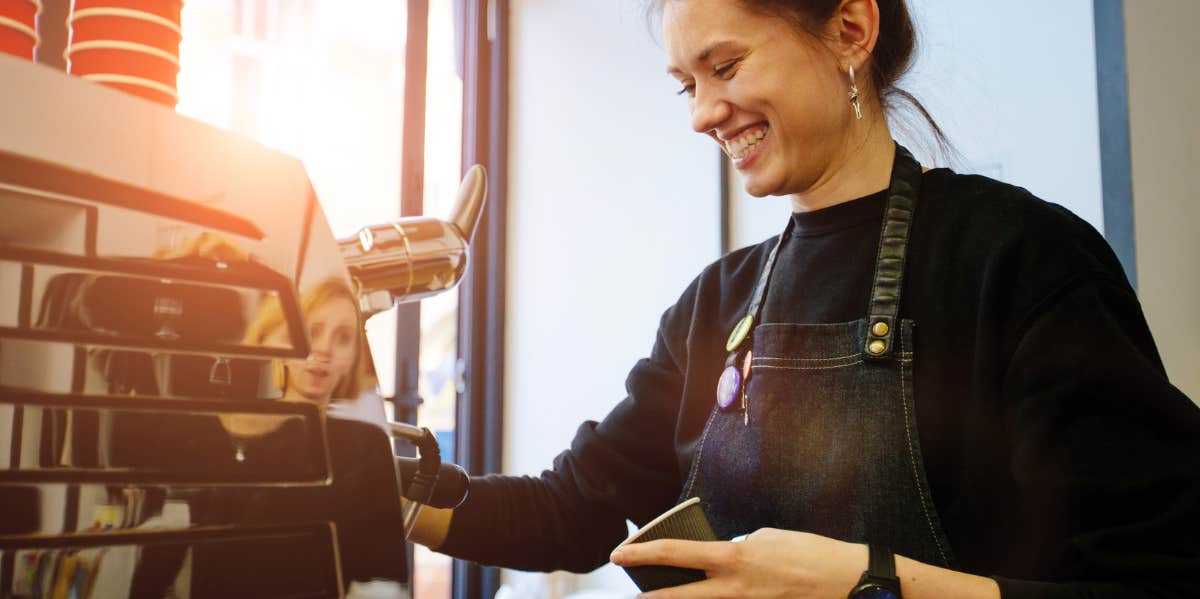 A barista laughing