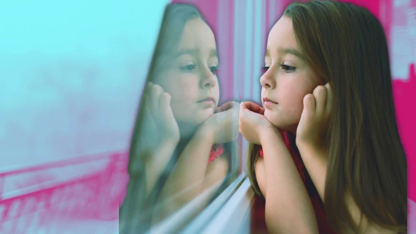 young girl looking out the window