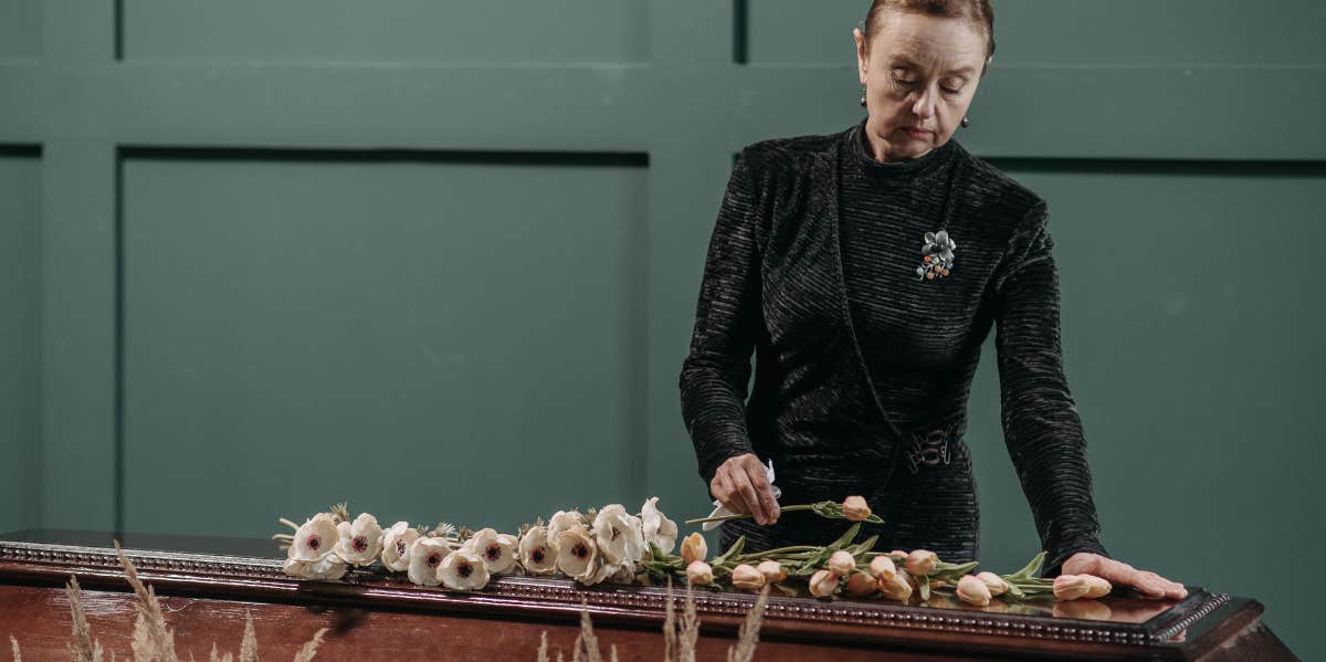 A woman in front of a coffin in a funeral