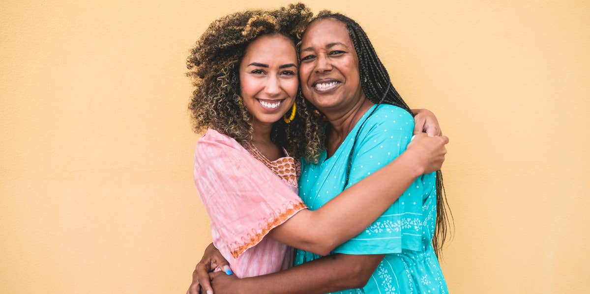 mother and adult daughter hugging