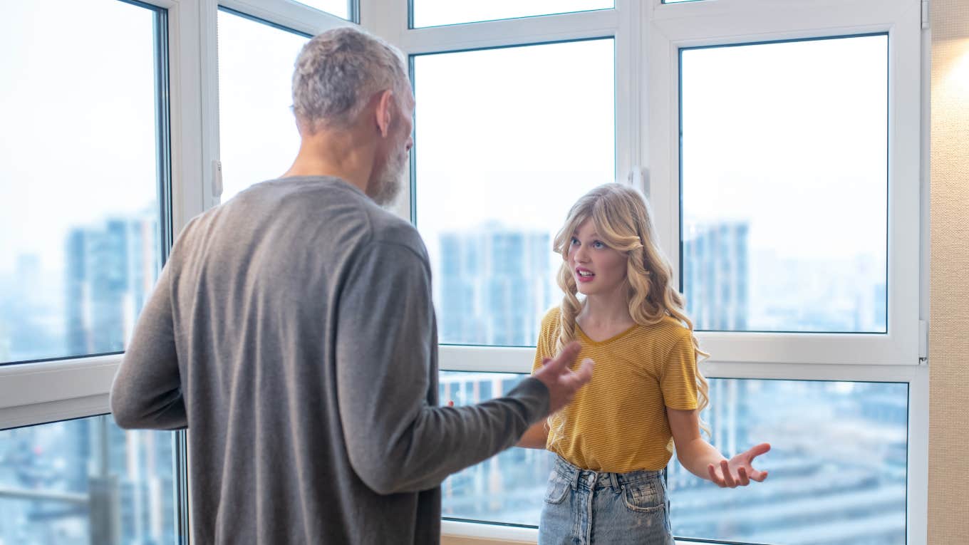 man arguing with teen stepdaughter