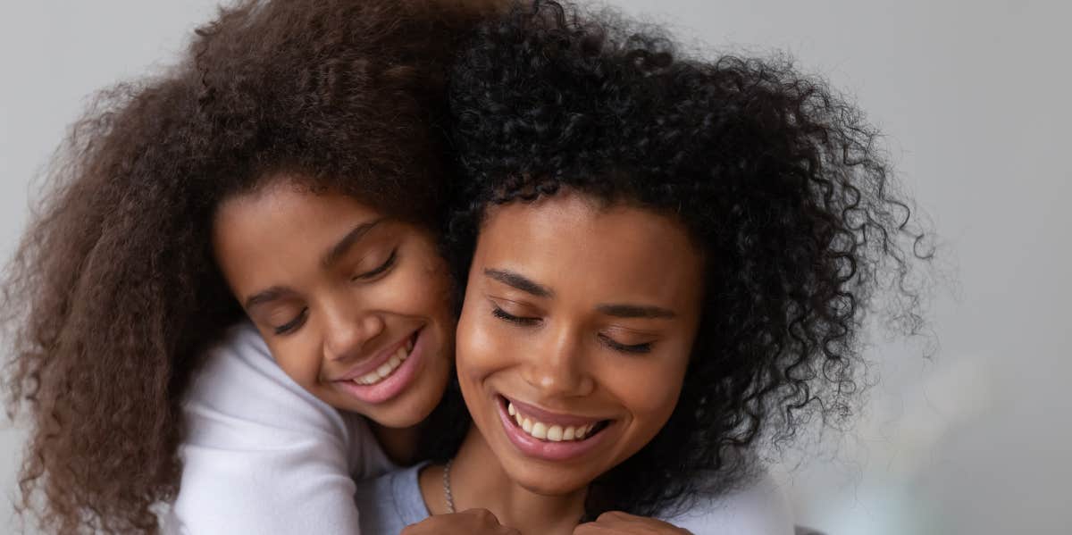 mom and daughter hugging