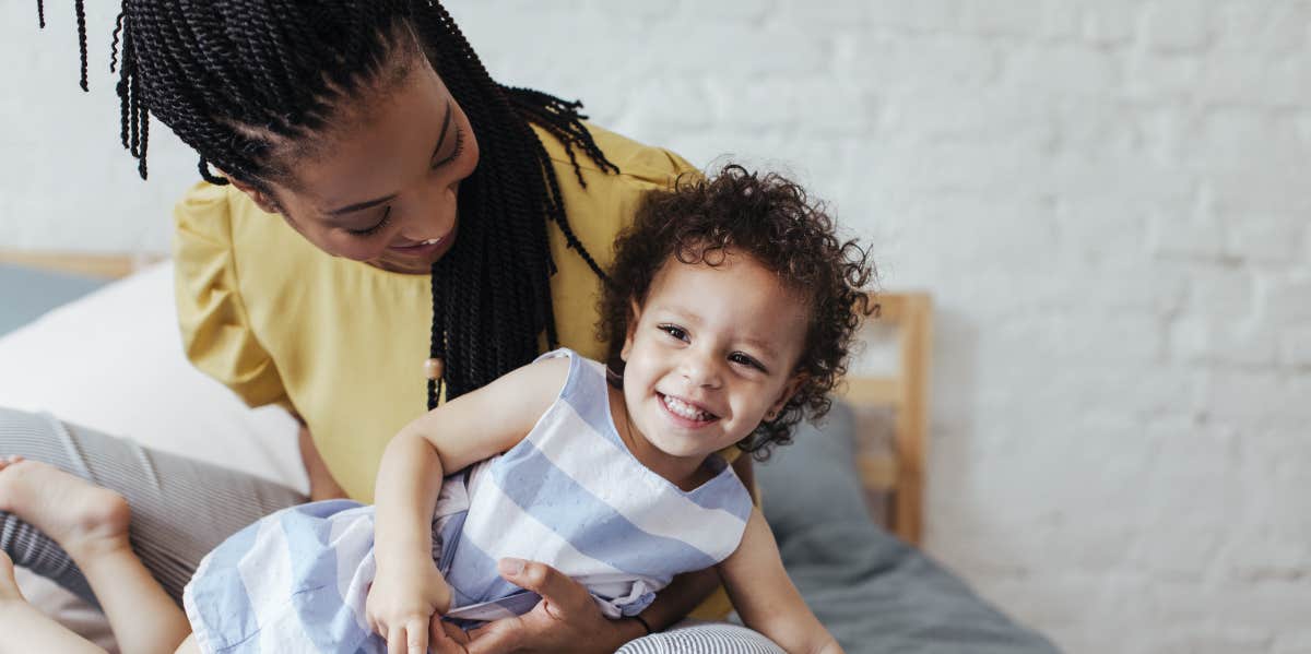 Mom cuddling with baby in bedroom