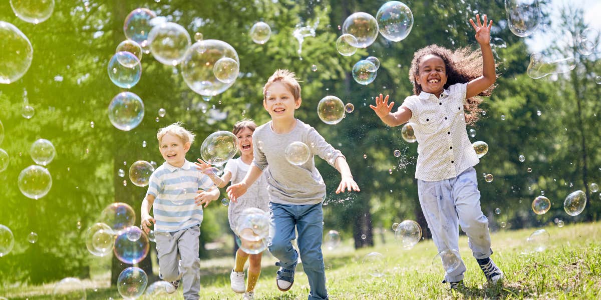 Group of children playing outside with bubbles
