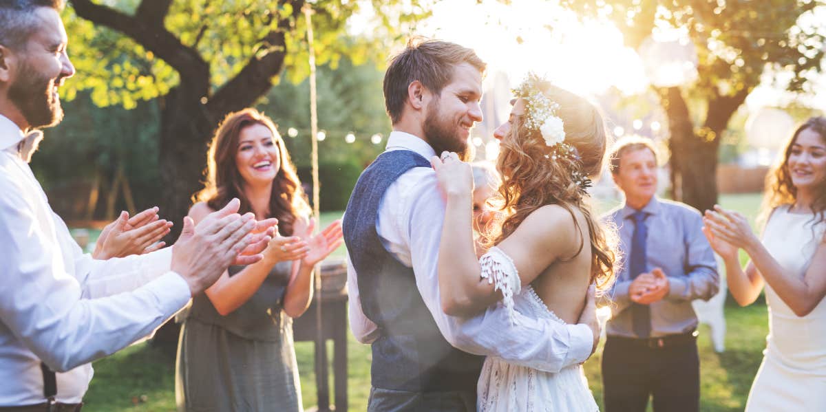 bride and groom dancing at wedding reception outside in the backyard