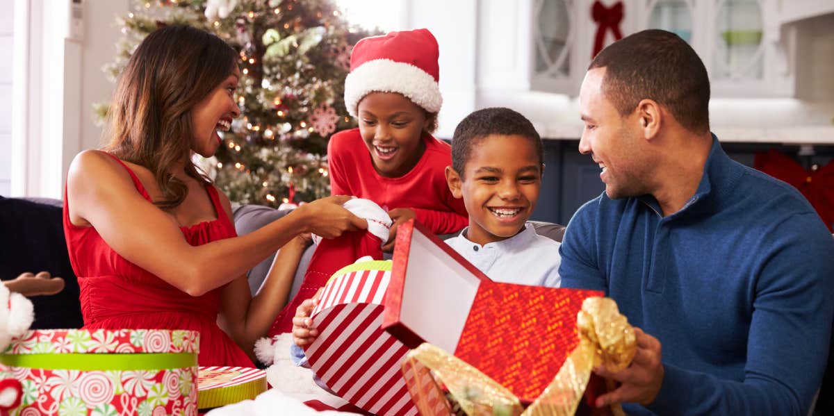 family opening christmas presents at home