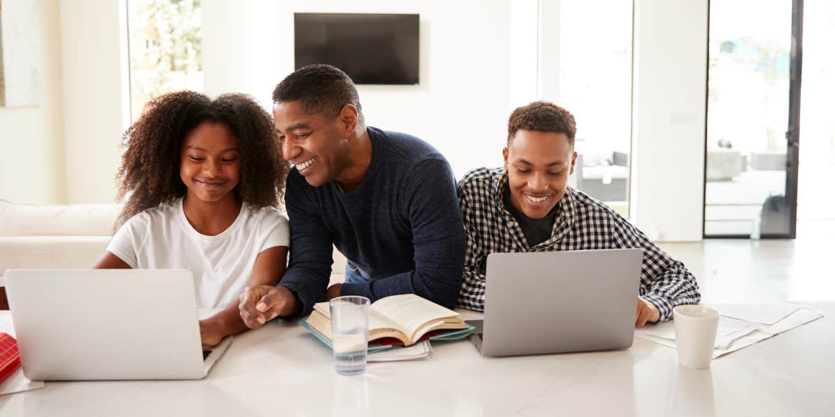 Dad helping his teen children with homework