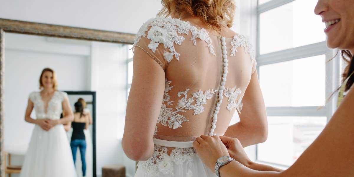 Bride trying on wedding dress