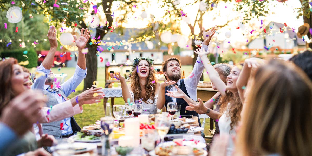 Woman Refuses To Take Daughter To Her Ex-Husband's Wedding, Sparking Debate bride and groom with wedding guests