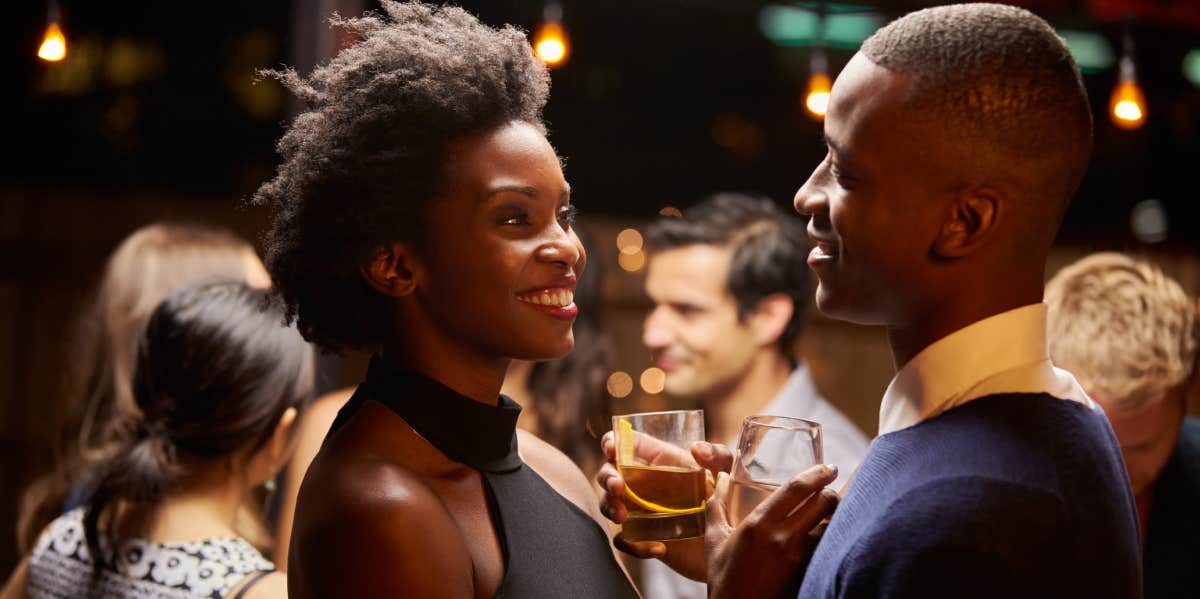 couple dancing and drinking at party