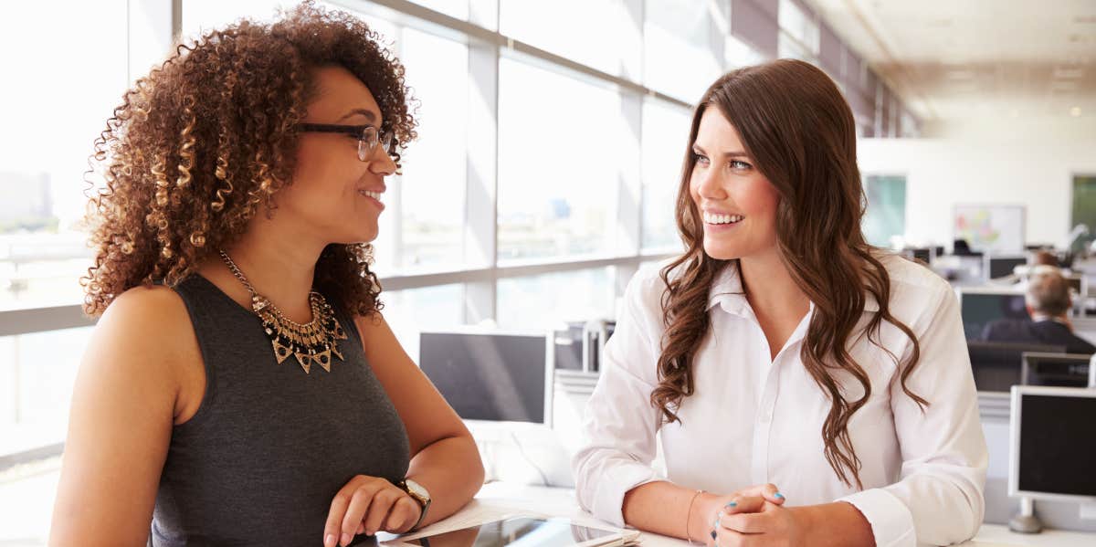 two women working together at office