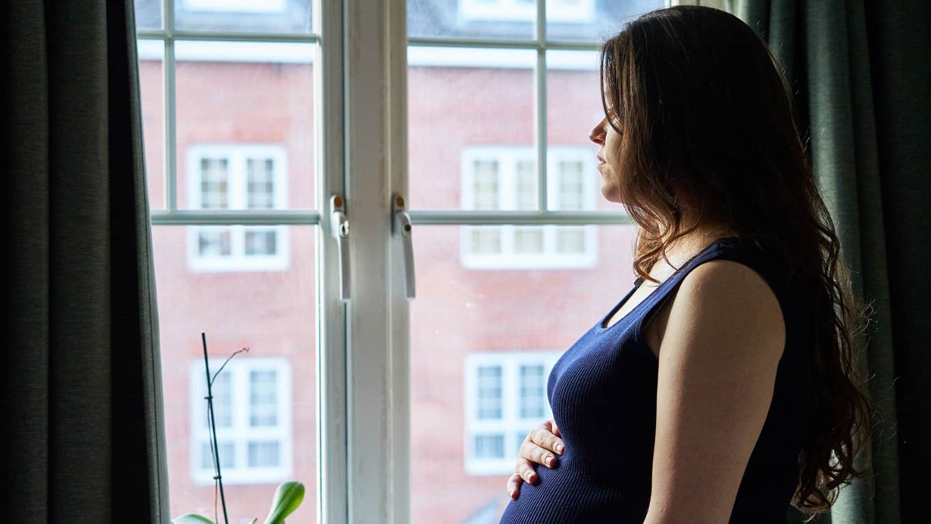 worried woman wondering how to tell her husband she's pregnant