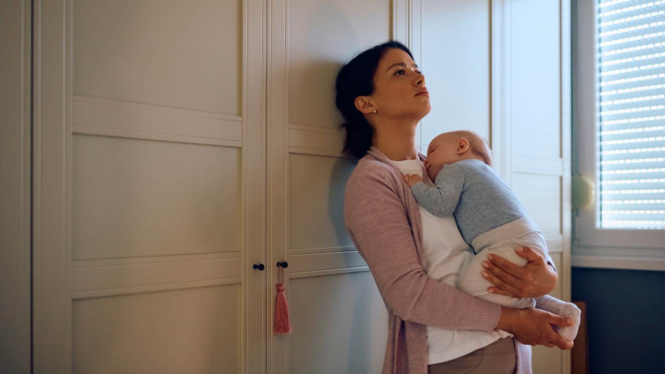 distraught woman holding her baby