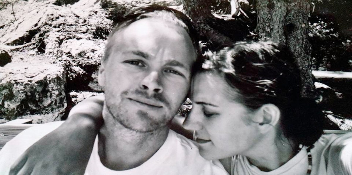 Woman putting her head on shoulder of man sitting next to her